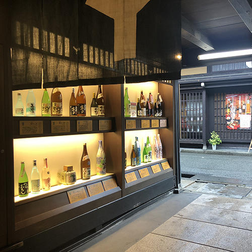 wall with sake bottles on display